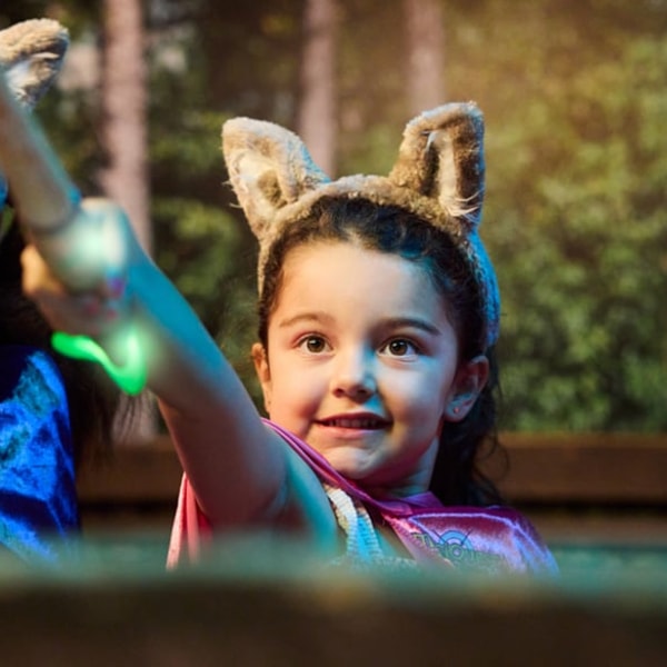 girl playing a MagiQuest game