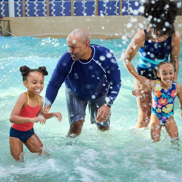 family in a wave pool