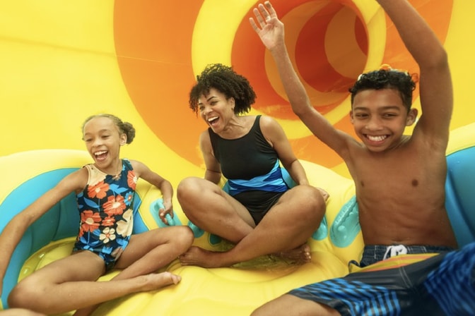family going down a water park slide