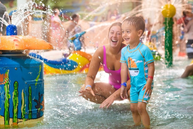 Mother and son splashin in the waterpark