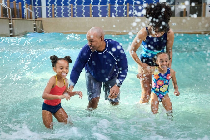 mother and two daughters in a wave pool
