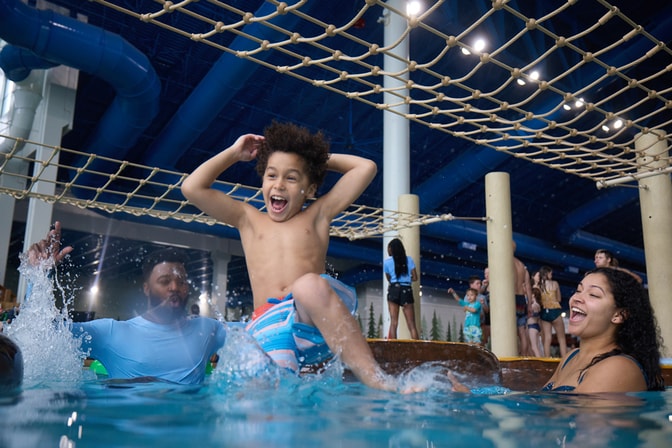 kid jumps into pool as parents watch excitedly