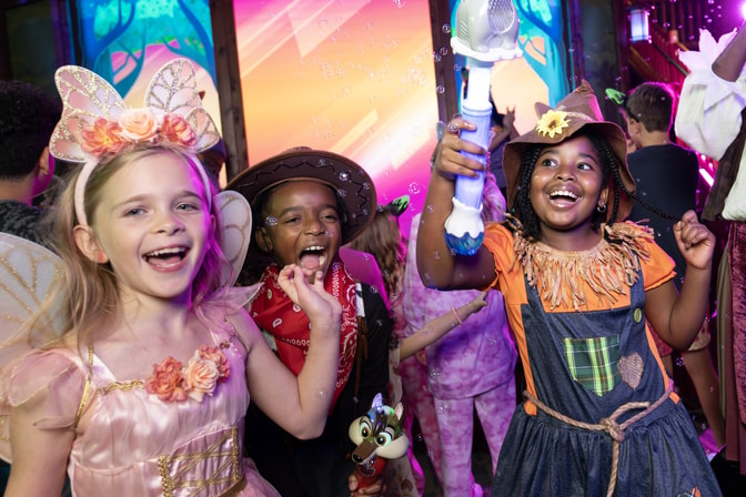 Children in costumes at colorful indoor entertainment venue
