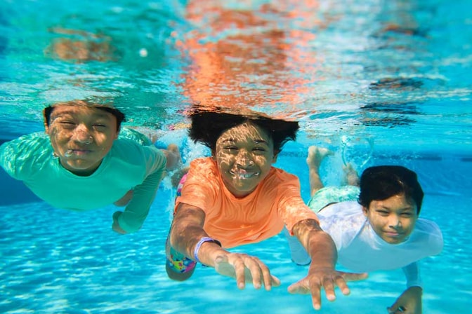young kids enjoying a dip in the pool