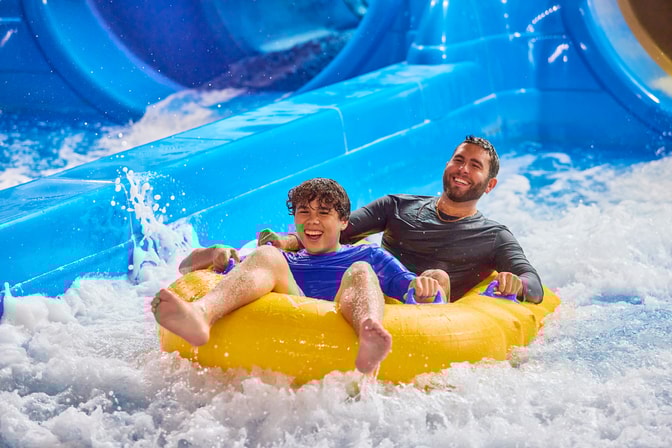 Father and son enjoying an indoor pool at Great Wolf Lodge