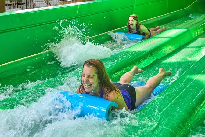 two girls enjoying water slides