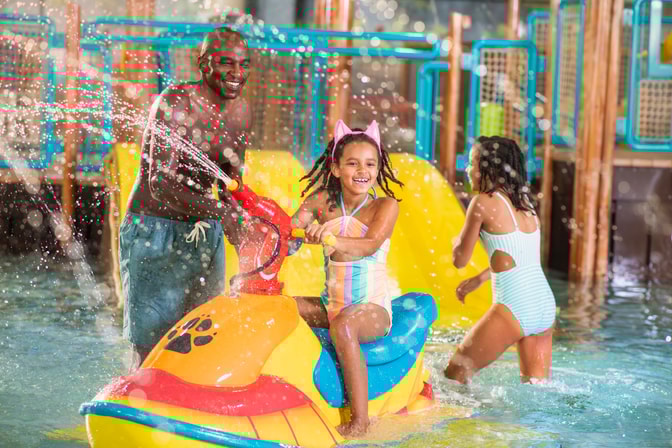 mother and girls enjoying indoor water park