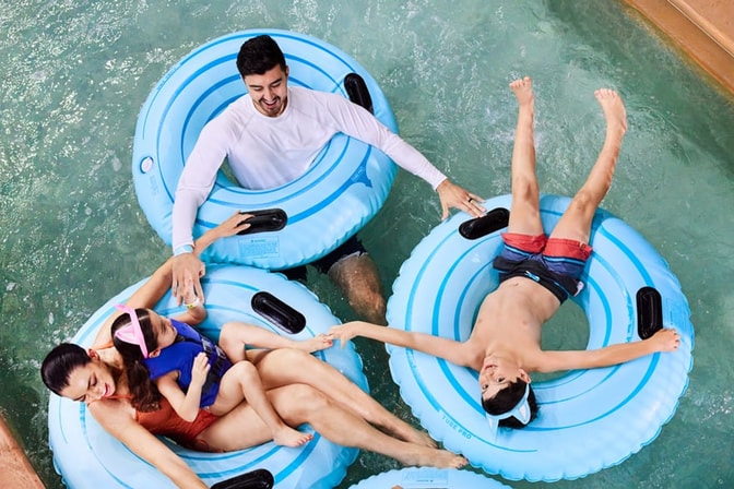 family in a lazy river pool