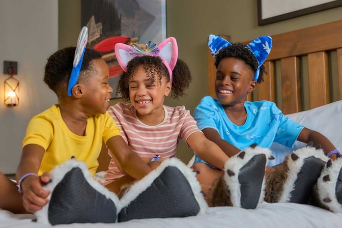 kids sitting on bed and smiling