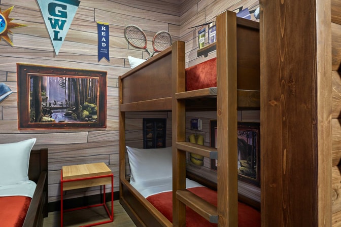 bunks beds and a day bed in a cabin themed suite