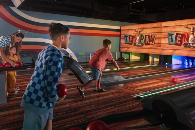 Guests playing bowling at the bowling alley