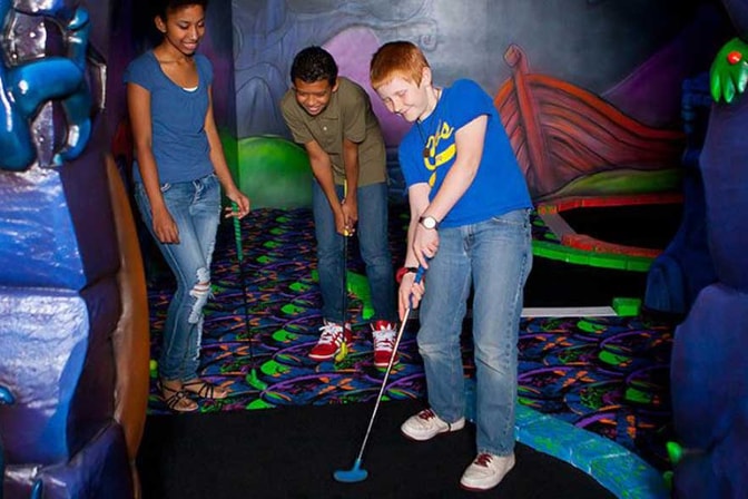 guests playing a game of mini golf
