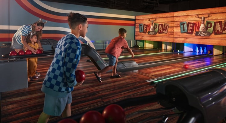 Boy smiling while playing bowling