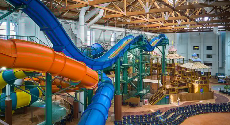 view of the indoor water park with orange and blue slides