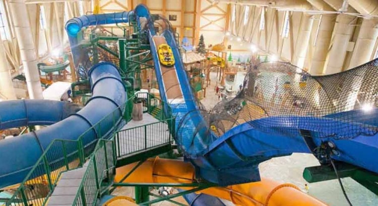 Wide view of the Niagara Rapids Run's multiple tube slides at Great Wolf Lodge indoor water park and resort.