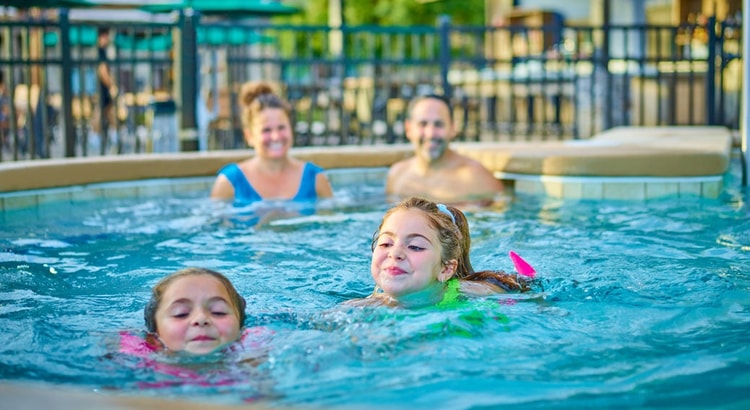 Kids and family having fun in pool