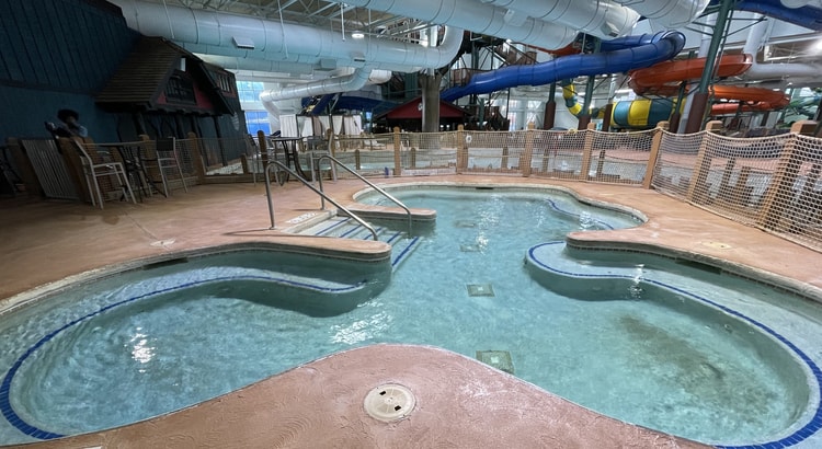 A family of four relaxes in the indoor pool