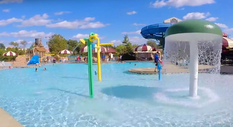 Kids play behind the outdoor water features 