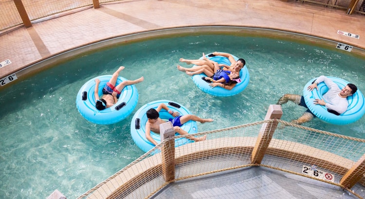 Family riding tubes enjoying the lazy river attraction