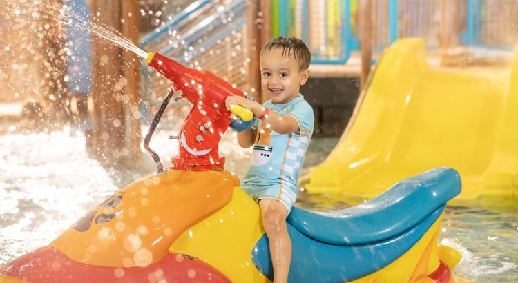 mother and child enjoying in a kidee pool in waterpark