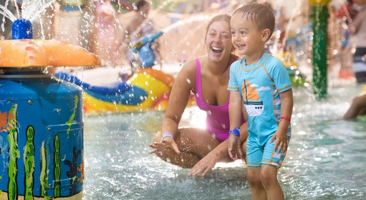 mother and child enjoying in a kidee pool in waterpark
