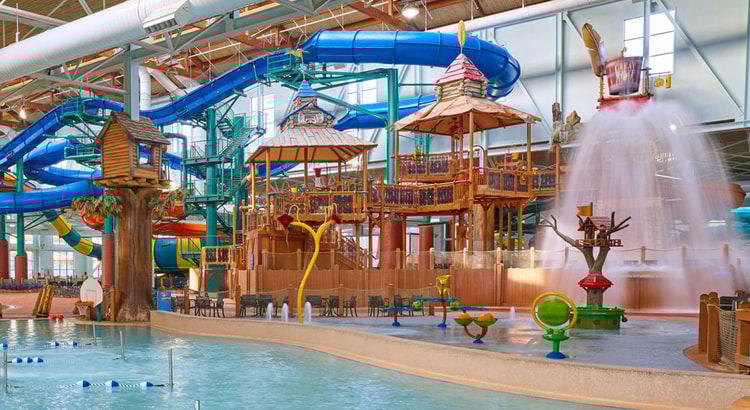 A wide shot of the water treehouse as water splashes down from a bucket