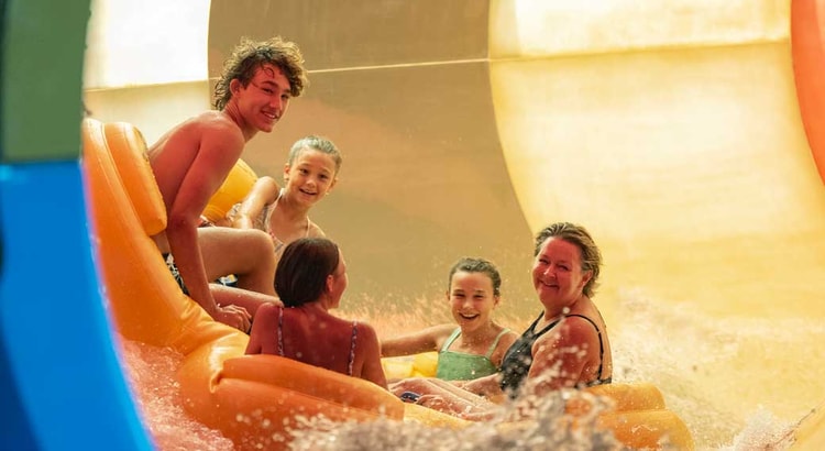 Family of five rides down enclosed waterslide 