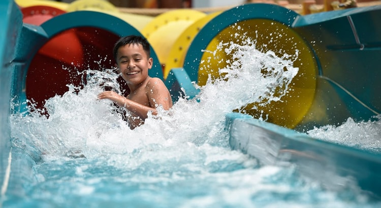 kid rides down waterslide