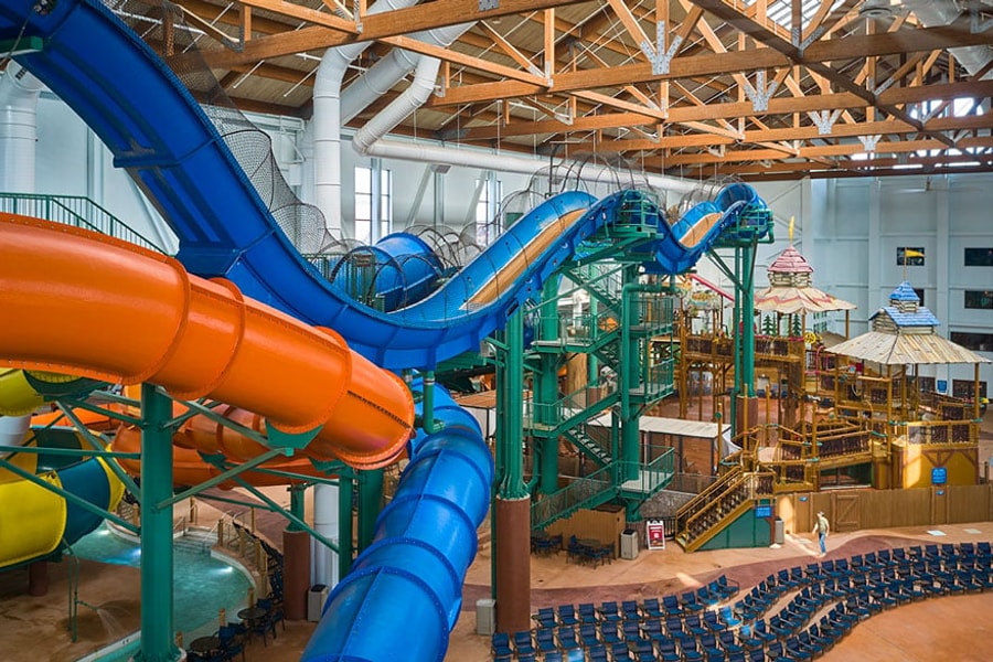 view of the indoor water park with orange and blue slides