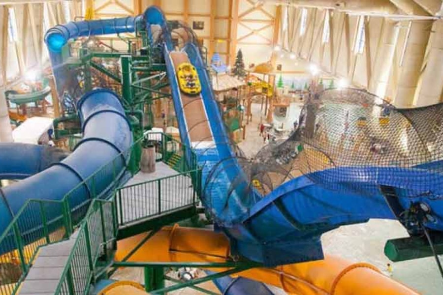 Wide view of the Niagara Rapids Run's multiple tube slides at Great Wolf Lodge indoor water park and resort.