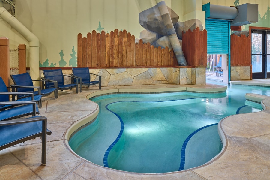A family of four relaxes in the indoor pool
