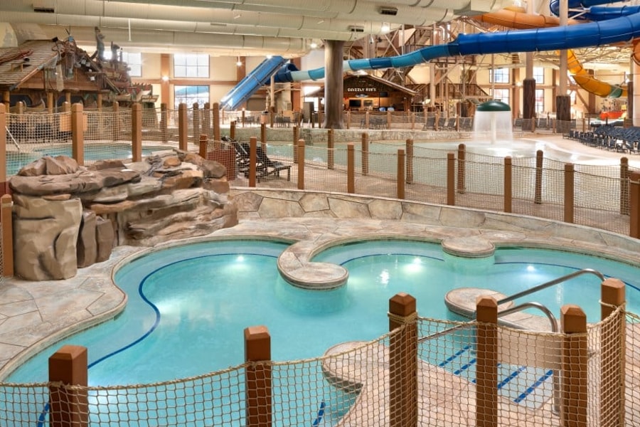 A family of four relaxes in the indoor pool