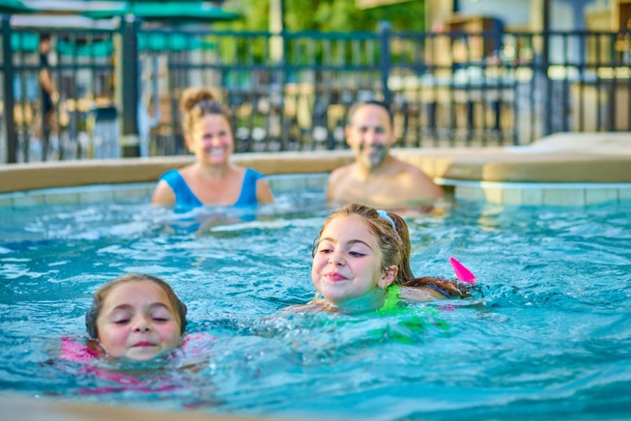 family of four having fun in the pool