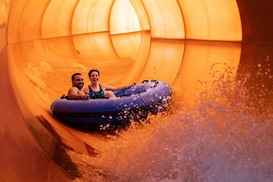 A family enjoys rafting together at Great Wolf Lodge indoor water park and resort.
