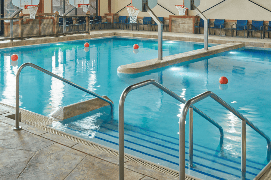A spacious indoor pool featuring a large slide and multiple water slides for recreational enjoyment.
