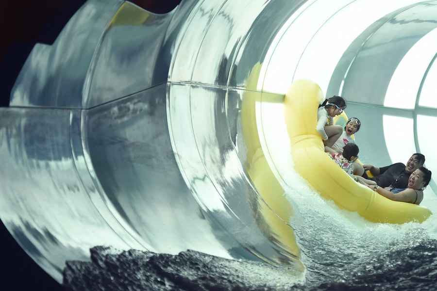 Family of five rides down enclosed waterslide
