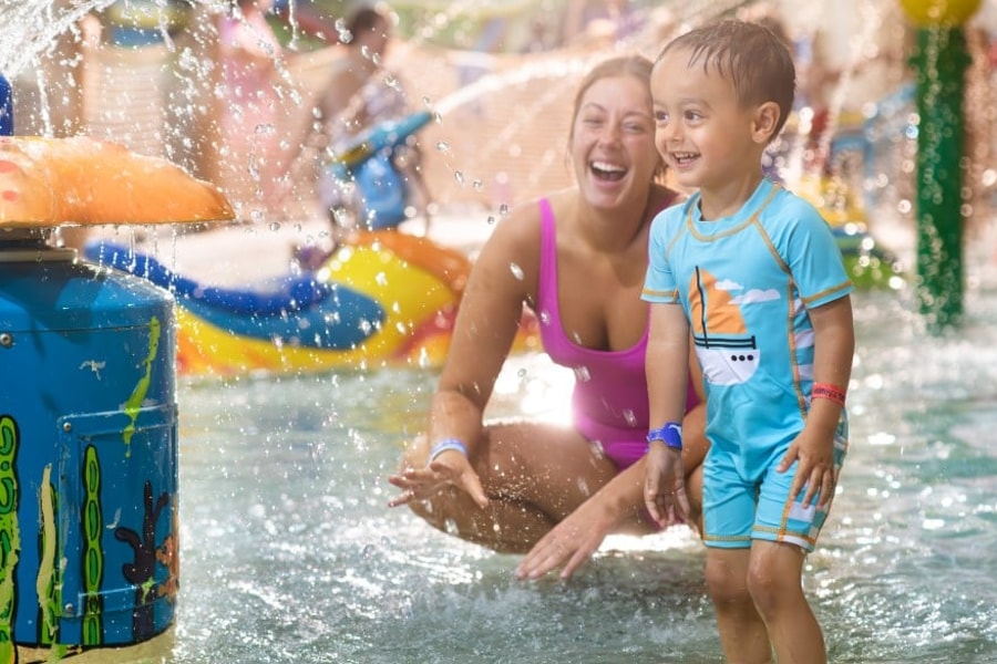 mother and child enjoying in a kidee pool in waterpark