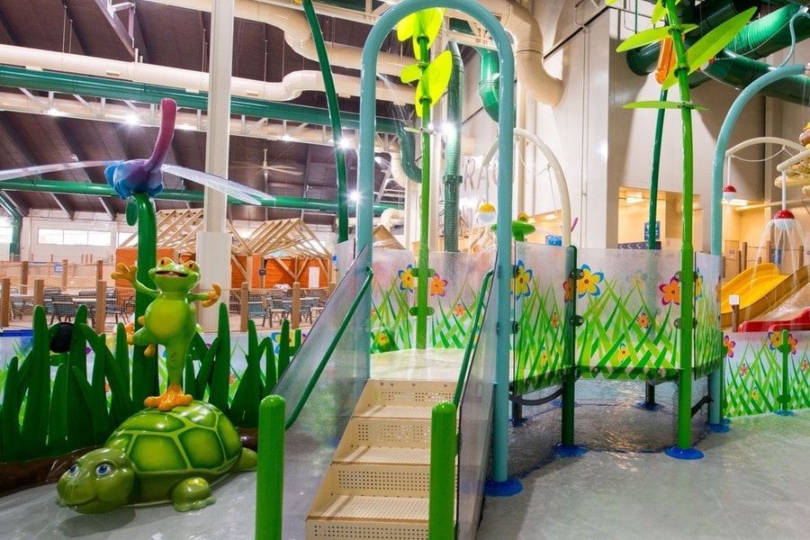 A vibrant water park featuring a large slide and a fun water play area for children.
