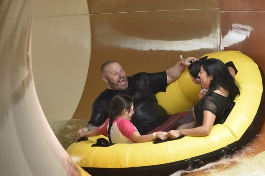 A family rides the Diamond Back Drop water slide