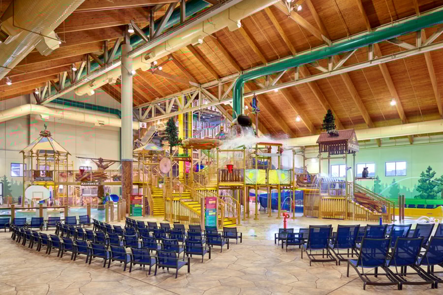 A wide shot of the  water treehouse as water splashes down from a bucket above the jungle gym