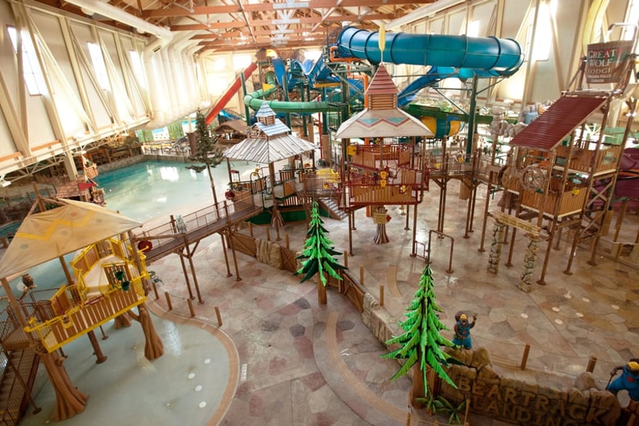 A wide shot of the  water treehouse as water splashes down from a bucket above the jungle gym