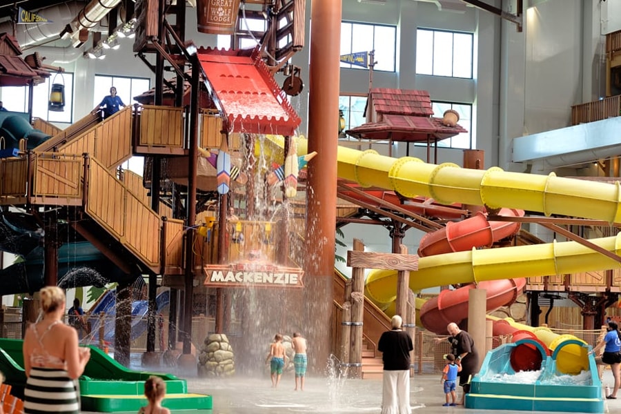 A wide shot of the  water treehouse as water splashes down from a bucket above the jungle gym