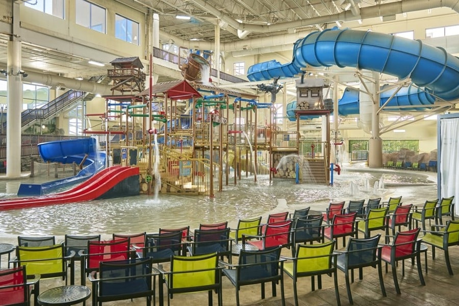 A wide shot of the  water treehouse as water splashes down from a bucket above the jungle gym