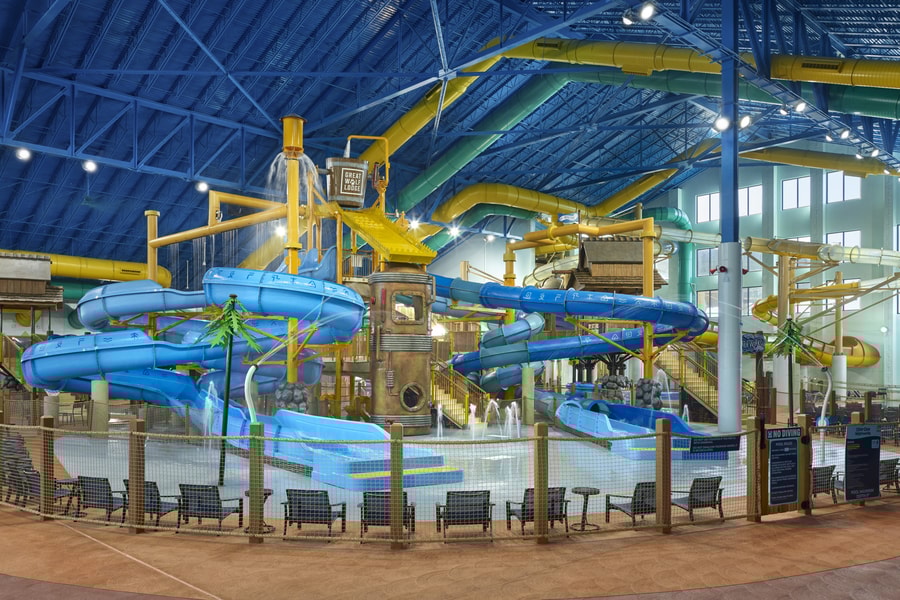 A wide shot of the  water treehouse as water splashes down from a bucket above the jungle gym