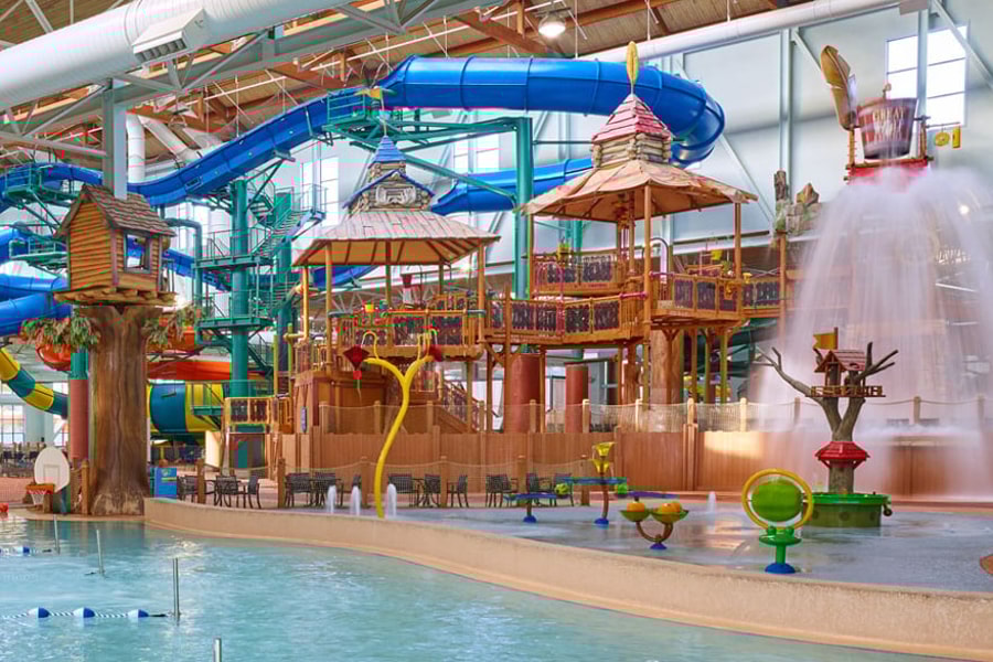 A wide shot of the water treehouse as water splashes down from a bucket