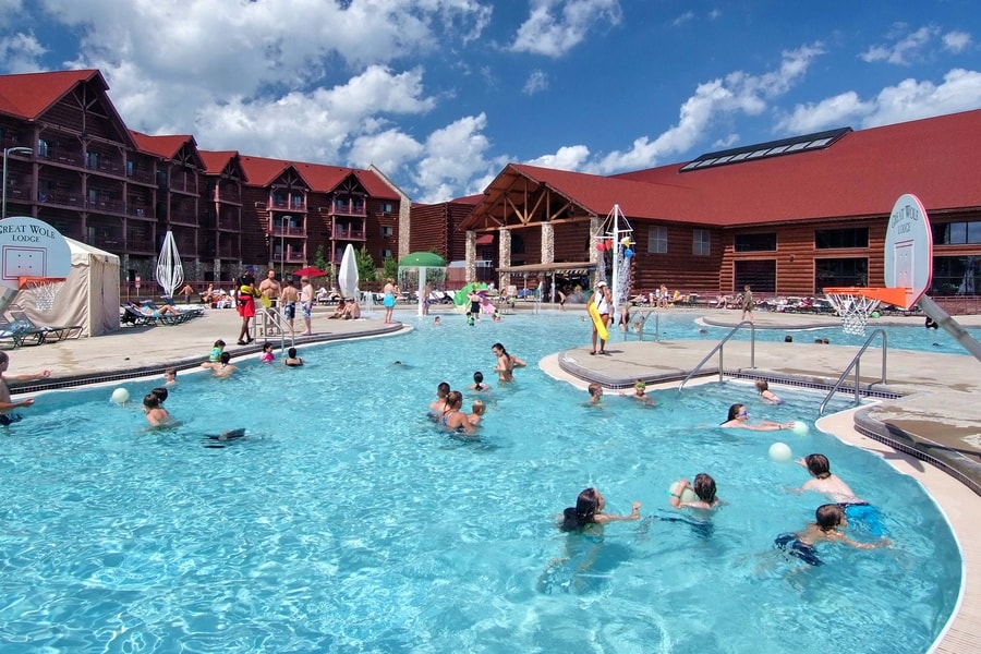 guests playing basketball in an outdoor pool