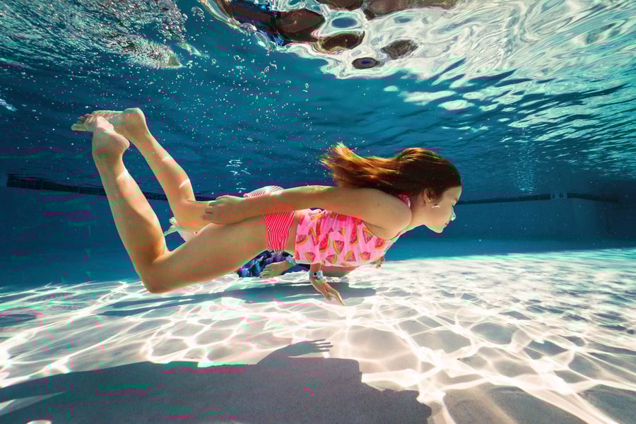 girl swimming under water