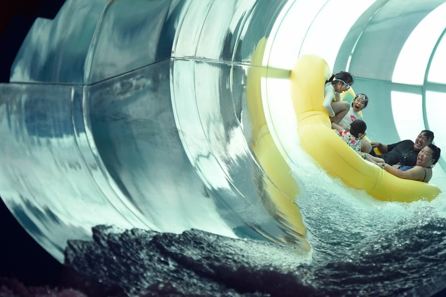 Family of five rides down enclosed waterslide 