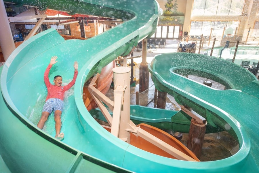 kid rides down waterslide