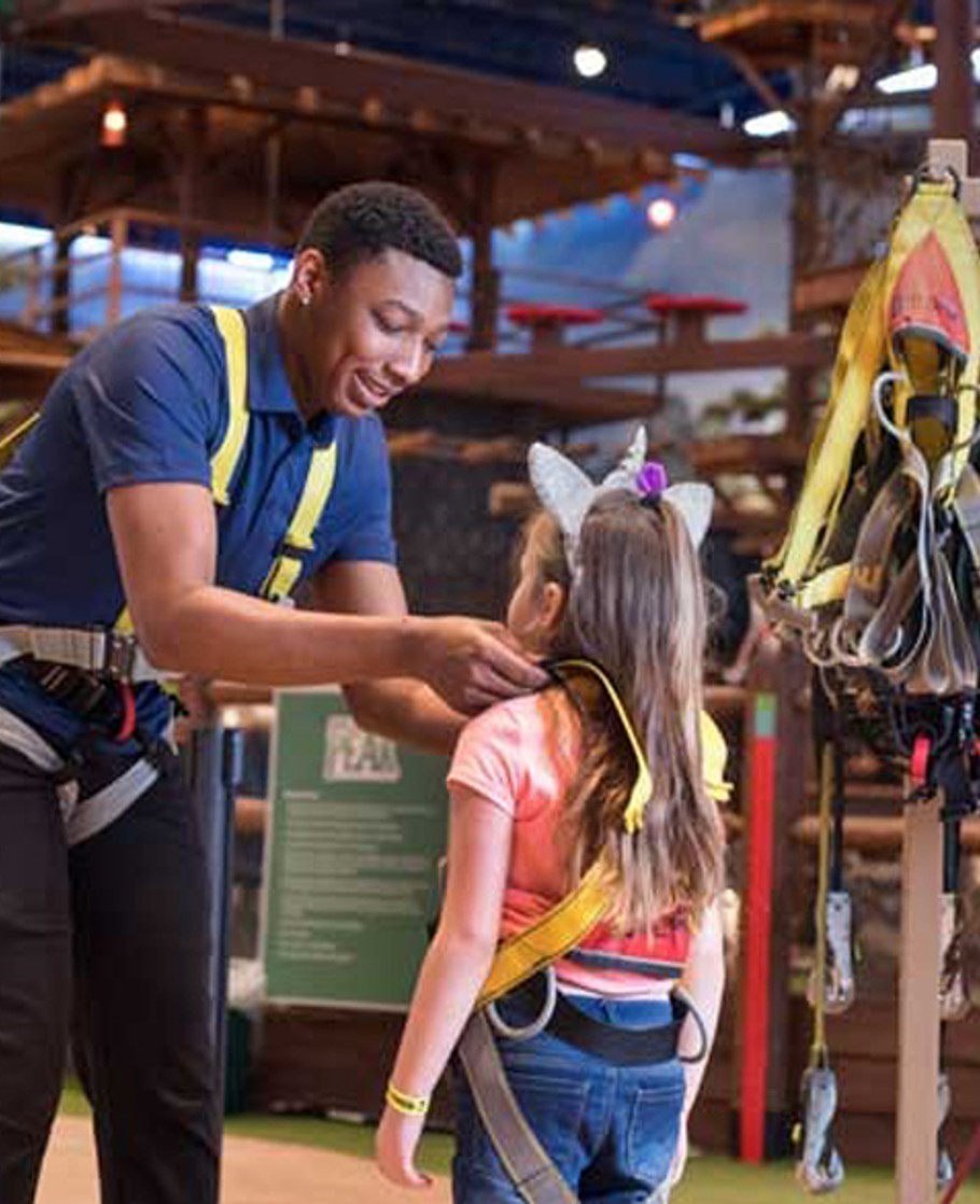 GW employee helps girl with her climbing harness
